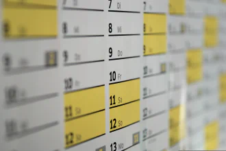Angled photo of a portion of a calendar with yellow highlighted dates.